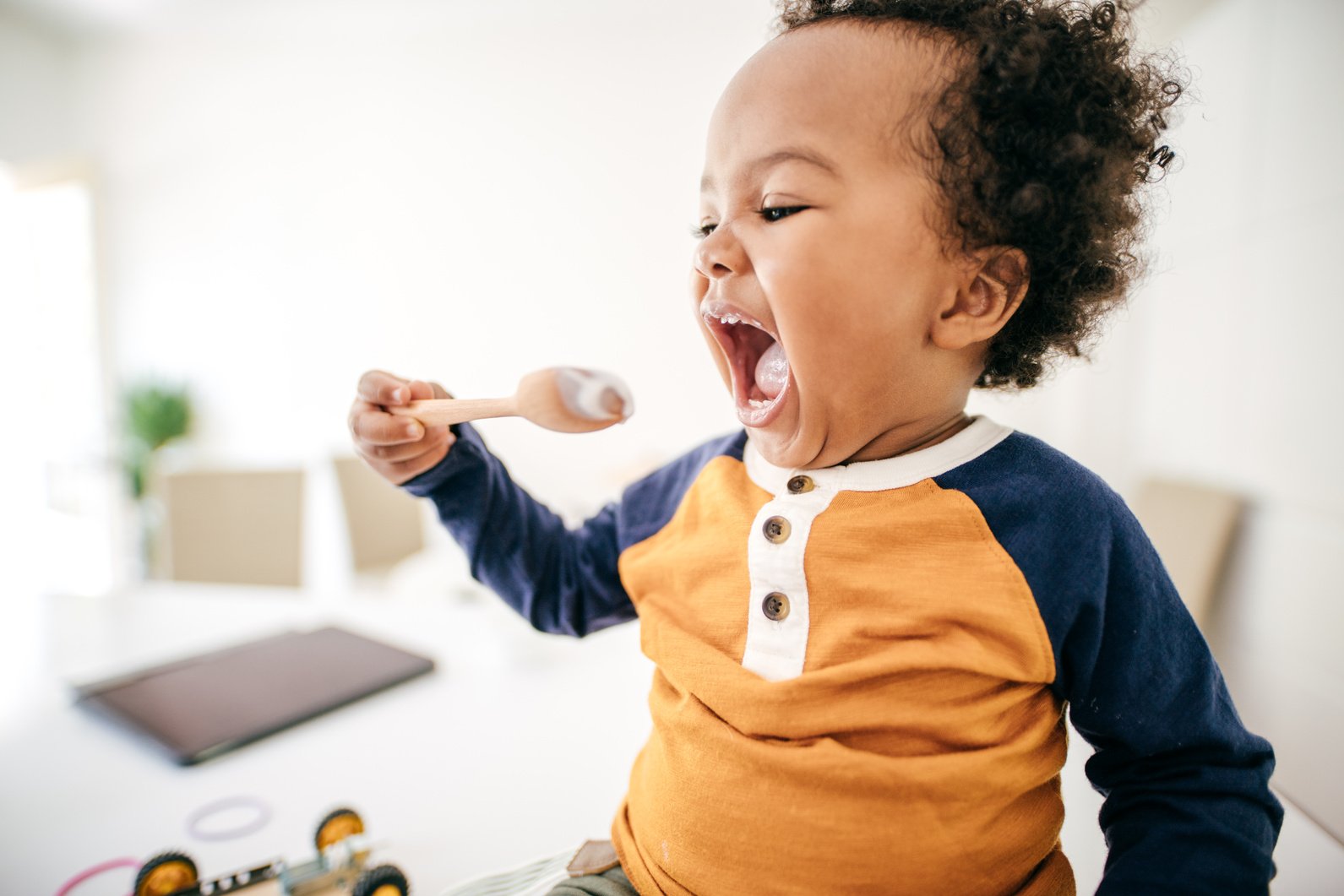 Toddler eating yogurt